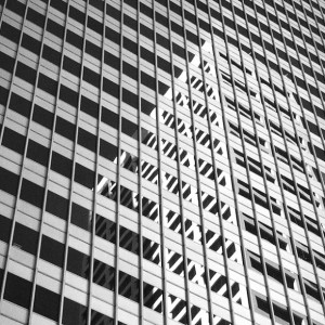 Black and white photo of reflections on buildings in downtown Minneapolis.
